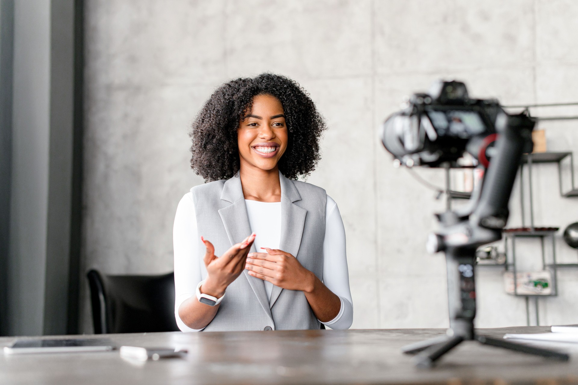 Businesswoman, teacher, mentor sitting in front of the camera, filming herself